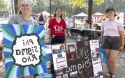 Students with signs at Student Organization Fair