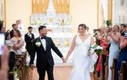 a couple walks down the aisle on their wedding day 